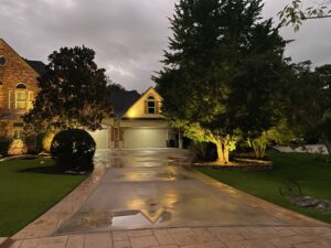 A gorgeous driveway lit up at night.