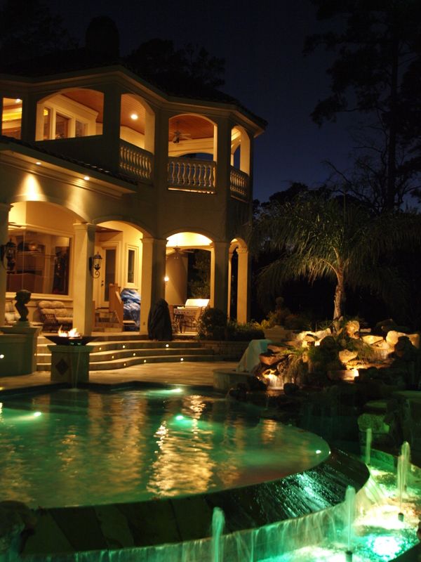 backyard patio lighting with pool and spa