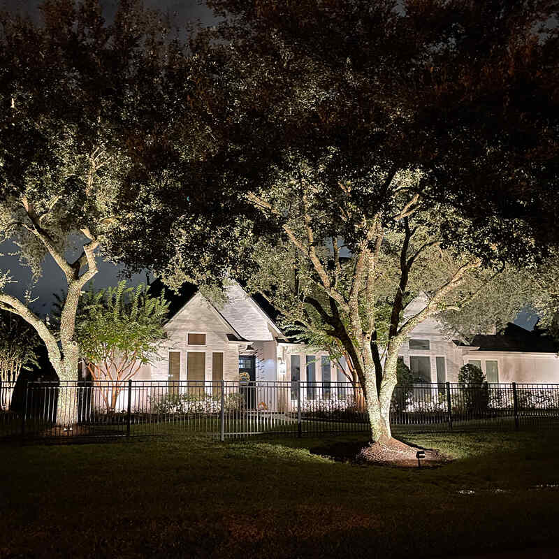 beautiful outdoor lighting on white home