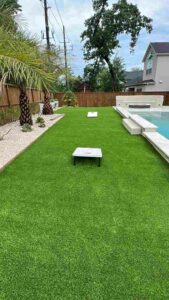 houston backyard with brand new turf and corn hole tables