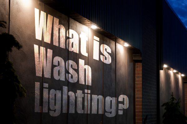 A building with wash lighting and the words, 